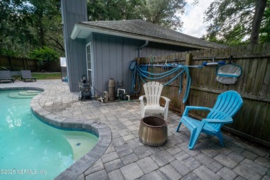 Fantastic pool home tucked away in a quiet Fort Caroline on Hidden Hills Country Club in Florida - for sale on GolfHomes.com, golf home, golf lot