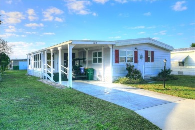 Turnkey 2/2 home in Barefoot Bay with stunning lake views! Enjoy on Barefoot Bay Golf Course in Florida - for sale on GolfHomes.com, golf home, golf lot