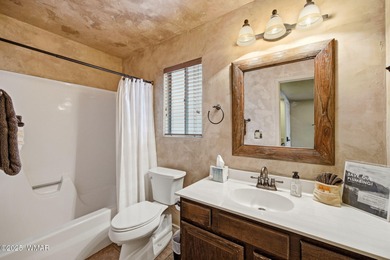 Step onto the spacious deck and take in breathtaking views of on Pinetop Lakes Golf and Country Club in Arizona - for sale on GolfHomes.com, golf home, golf lot