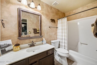 Step onto the spacious deck and take in breathtaking views of on Pinetop Lakes Golf and Country Club in Arizona - for sale on GolfHomes.com, golf home, golf lot