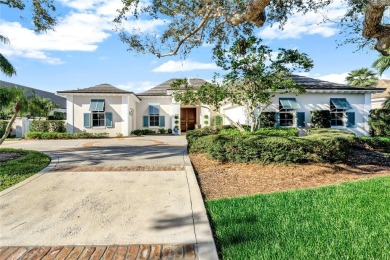 This stunning courtyard pool home with serene lake views has on Orchid Island Golf and Beach Club in Florida - for sale on GolfHomes.com, golf home, golf lot