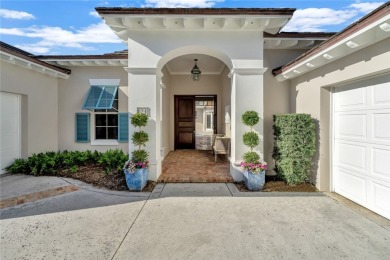 This stunning courtyard pool home with serene lake views has on Orchid Island Golf and Beach Club in Florida - for sale on GolfHomes.com, golf home, golf lot