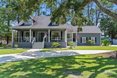 Located in Wedgewood Estates, this Gulf Shores retreat with a on The Golf Club of the Wharf in Alabama - for sale on GolfHomes.com, golf home, golf lot