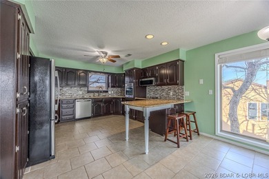 This isn't your typical lake condo-step inside and you'll feel on Lake Valley Country Club in Missouri - for sale on GolfHomes.com, golf home, golf lot