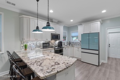 Welcome to 301 NE 51st Street where island life meets everyday on Founders Club At St. James Plantation in North Carolina - for sale on GolfHomes.com, golf home, golf lot