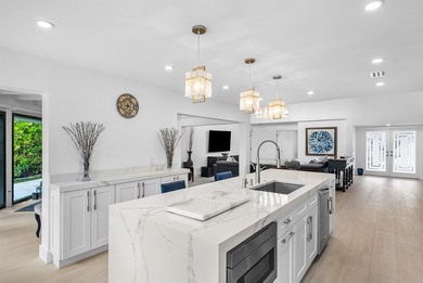 An exceptional, fully renovated retreat tucked behind a tranquil on Hamlet Country Club in Florida - for sale on GolfHomes.com, golf home, golf lot