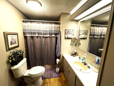 Experience comfortable living in this beautifully updated on Lake Henry Golf Club in Florida - for sale on GolfHomes.com, golf home, golf lot