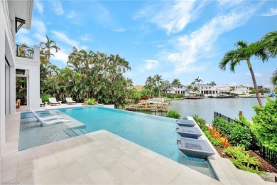 Experience unparalleled luxury in this exceptional bay front on The Moorings Country Club in Florida - for sale on GolfHomes.com, golf home, golf lot