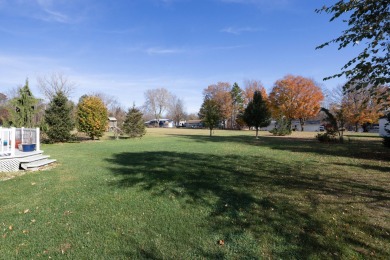 This stunning home situated on a well-manicured 1 acre lot is on Paw Paw Lake Golf Course in Michigan - for sale on GolfHomes.com, golf home, golf lot