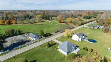 This stunning home situated on a well-manicured 1 acre lot is on Paw Paw Lake Golf Course in Michigan - for sale on GolfHomes.com, golf home, golf lot