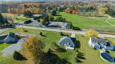 This stunning home situated on a well-manicured 1 acre lot is on Paw Paw Lake Golf Course in Michigan - for sale on GolfHomes.com, golf home, golf lot