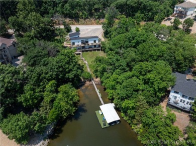 The views from this modernly constructed lakefront home are on Seasons Ridge At Four Seasons in Missouri - for sale on GolfHomes.com, golf home, golf lot