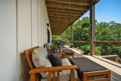 The views from this modernly constructed lakefront home are on Seasons Ridge At Four Seasons in Missouri - for sale on GolfHomes.com, golf home, golf lot