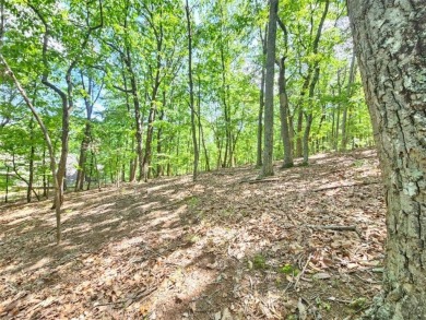 Nestled within the serene and exclusive Big Canoe community in on Big Canoe Golf Club - Cherokee in Georgia - for sale on GolfHomes.com, golf home, golf lot