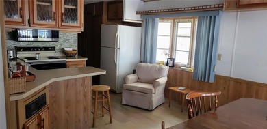 TWO BEDROOM, ONE BATH MOBILE HOME IN ACTIVE 55+ COMMUNITY! This on River Run Golf Links in Florida - for sale on GolfHomes.com, golf home, golf lot