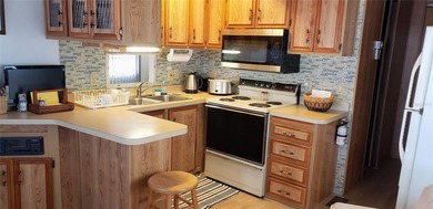 TWO BEDROOM, ONE BATH MOBILE HOME IN ACTIVE 55+ COMMUNITY! This on River Run Golf Links in Florida - for sale on GolfHomes.com, golf home, golf lot