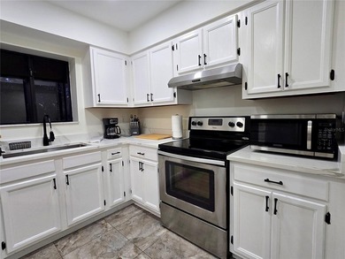 Enjoy Florida's lifestyle at its best in this renovated top on Countryside Country Club in Florida - for sale on GolfHomes.com, golf home, golf lot