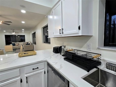 Enjoy Florida's lifestyle at its best in this renovated top on Countryside Country Club in Florida - for sale on GolfHomes.com, golf home, golf lot