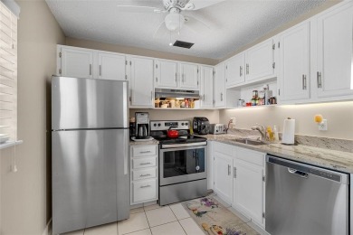 This charming partially furnished 2BR/2BA condo in Vista Royale on The American Golf Club in Florida - for sale on GolfHomes.com, golf home, golf lot