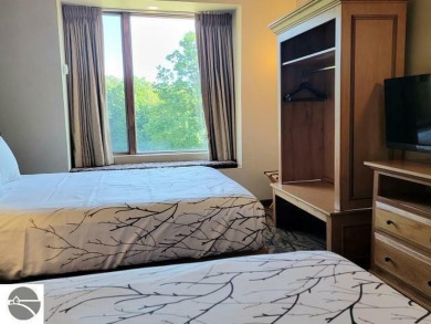 This second-floor Lodge suite offers picturesque views of both on Cedar River Golf Course in Michigan - for sale on GolfHomes.com, golf home, golf lot