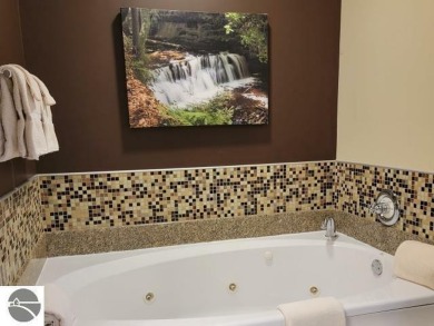 This second-floor Lodge suite offers picturesque views of both on Cedar River Golf Course in Michigan - for sale on GolfHomes.com, golf home, golf lot