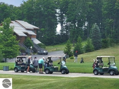 This second-floor Lodge suite offers picturesque views of both on Cedar River Golf Course in Michigan - for sale on GolfHomes.com, golf home, golf lot