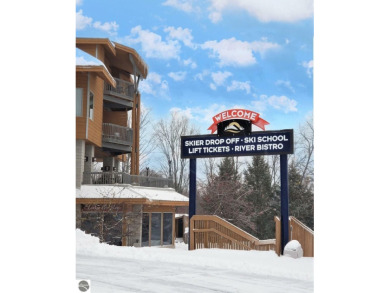 This second-floor Lodge suite offers picturesque views of both on Cedar River Golf Course in Michigan - for sale on GolfHomes.com, golf home, golf lot