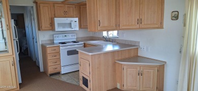 Park model with a separate shed that includes a Roper/Whirlpool on Great Eagle Golf Club in Arizona - for sale on GolfHomes.com, golf home, golf lot