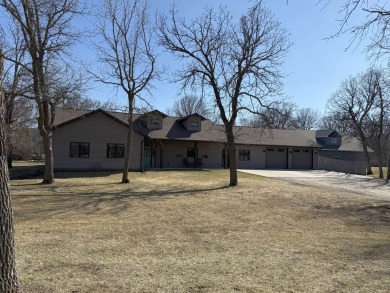 Nestled on a serene treed lot, this stunning one-story on Devils Lake Town and Country Club in North Dakota - for sale on GolfHomes.com, golf home, golf lot