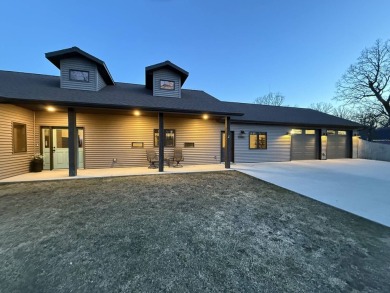 Nestled on a serene treed lot, this stunning one-story on Devils Lake Town and Country Club in North Dakota - for sale on GolfHomes.com, golf home, golf lot