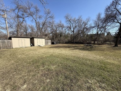 Nestled on a serene treed lot, this stunning one-story on Devils Lake Town and Country Club in North Dakota - for sale on GolfHomes.com, golf home, golf lot