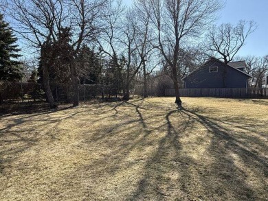 Nestled on a serene treed lot, this stunning one-story on Devils Lake Town and Country Club in North Dakota - for sale on GolfHomes.com, golf home, golf lot