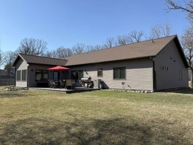 Nestled on a serene treed lot, this stunning one-story on Devils Lake Town and Country Club in North Dakota - for sale on GolfHomes.com, golf home, golf lot