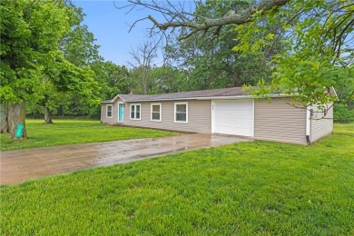 This remodeled ranch home in a gated community boasts four on Linn Valley Lakes - Deer Trace Golf Course in Kansas - for sale on GolfHomes.com, golf home, golf lot