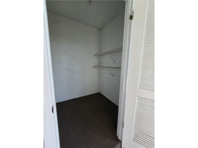 Your canvas awaits! Just needs a little TLC to make it shine on The American Golf Club in Florida - for sale on GolfHomes.com, golf home, golf lot