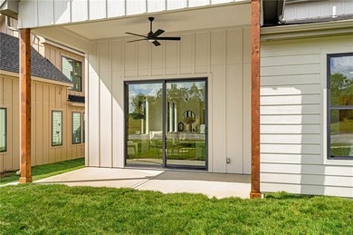 Discover modern, low-maintenance luxury living in this stunning on The Golf Club of Kansas in Kansas - for sale on GolfHomes.com, golf home, golf lot