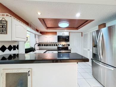 Lakefront Living in Beacon Woods Village with no flood insurance on Beacon Woods Golf Club in Florida - for sale on GolfHomes.com, golf home, golf lot