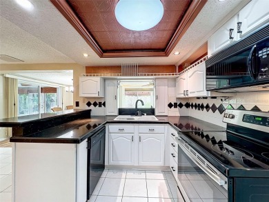Lakefront Living in Beacon Woods Village with no flood insurance on Beacon Woods Golf Club in Florida - for sale on GolfHomes.com, golf home, golf lot