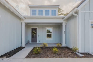 This nearly new ''Shoal'' with farmhouse elevation overlooks a on Hampton Pointe Golf Course in South Carolina - for sale on GolfHomes.com, golf home, golf lot