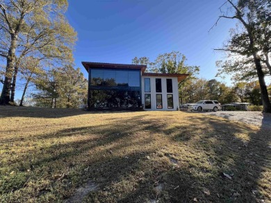 Experience the welcoming beauty of this two story Unrique Modern on Glenwood Country Club in Arkansas - for sale on GolfHomes.com, golf home, golf lot