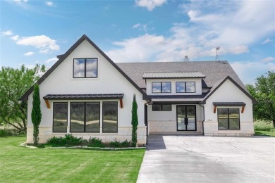 This exquisite custom residence within the great Hideout on Hideout Golf Club and Resort  in Texas - for sale on GolfHomes.com, golf home, golf lot