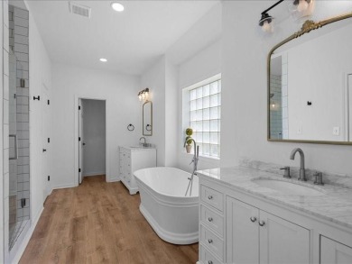 This stunning home, located at the corner of holes 15 and 16 on The Lake Country Club - Lake Waco in Texas - for sale on GolfHomes.com, golf home, golf lot