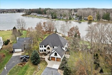 This unique Canadian Lakes waterfront estate offers an exquisite on Canadian Lakes Country Club-The Highlands Course in Michigan - for sale on GolfHomes.com, golf home, golf lot