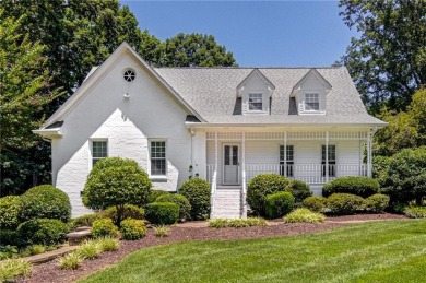 Classic white brick beauty nestled on the 16th fairway of Forest on Forest Oaks Country Club in North Carolina - for sale on GolfHomes.com, golf home, golf lot