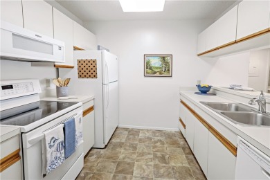 Enjoy resort-style living in this bright 2nd-floor corner unit on Vista Plantation Golf Club in Florida - for sale on GolfHomes.com, golf home, golf lot