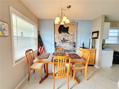 Meticulously maintained end unit with updated kitchen and baths on The American Golf Club in Florida - for sale on GolfHomes.com, golf home, golf lot