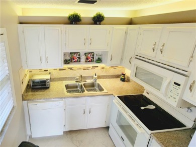 Meticulously maintained end unit with updated kitchen and baths on The American Golf Club in Florida - for sale on GolfHomes.com, golf home, golf lot