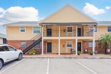 Welcome to this charming first-floor end-unit condo located in on East Bay Golf Club in Florida - for sale on GolfHomes.com, golf home, golf lot