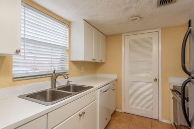 Welcome to this charming first-floor end-unit condo located in on East Bay Golf Club in Florida - for sale on GolfHomes.com, golf home, golf lot