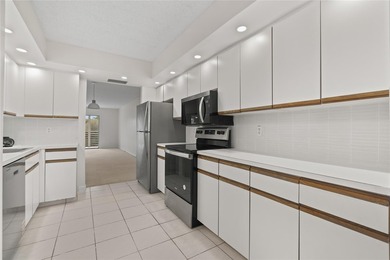 Experience the vibrant, active South Florida lifestyle in this on Wynmoor Golf Course in Florida - for sale on GolfHomes.com, golf home, golf lot